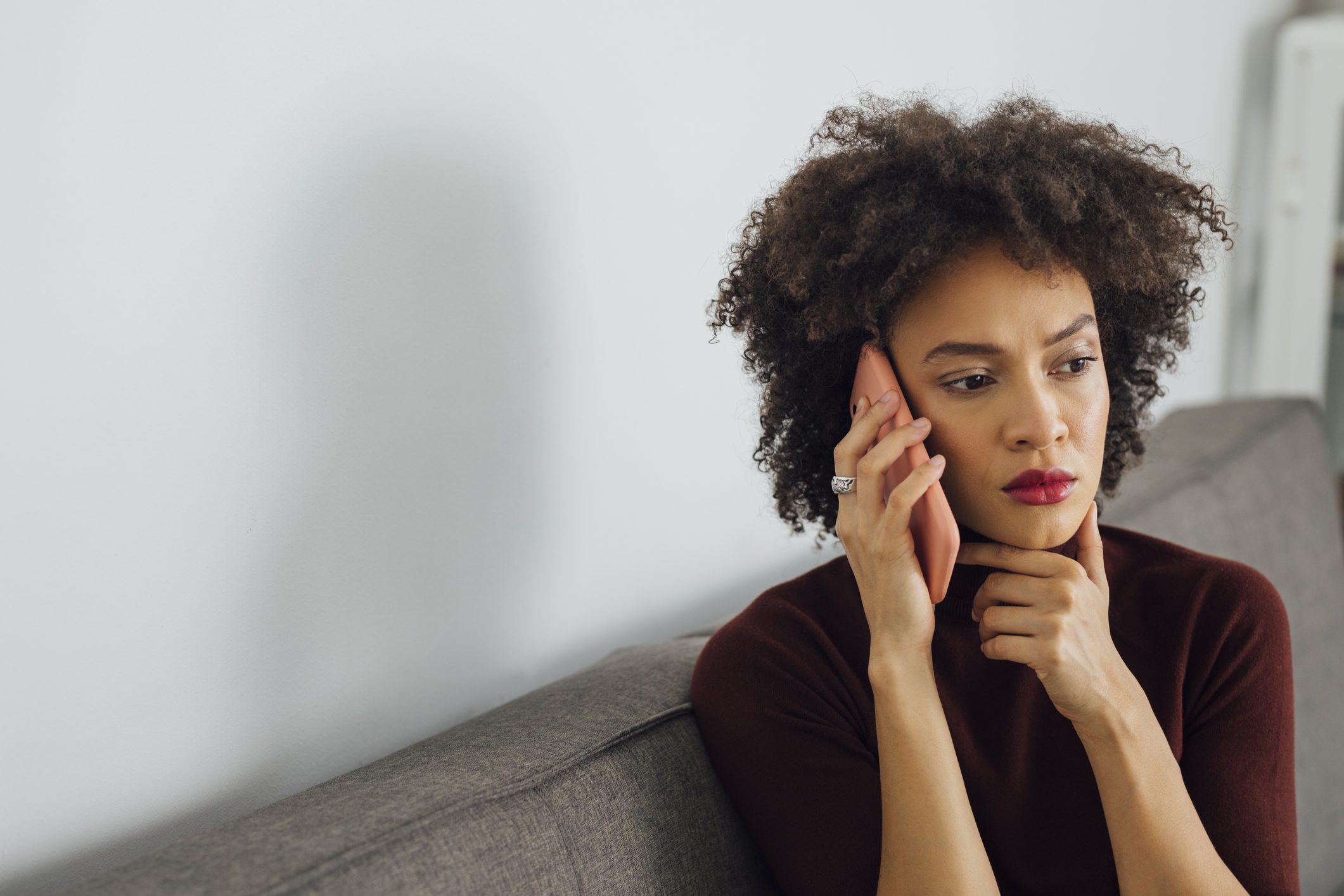 Person on the phone looking stressed.